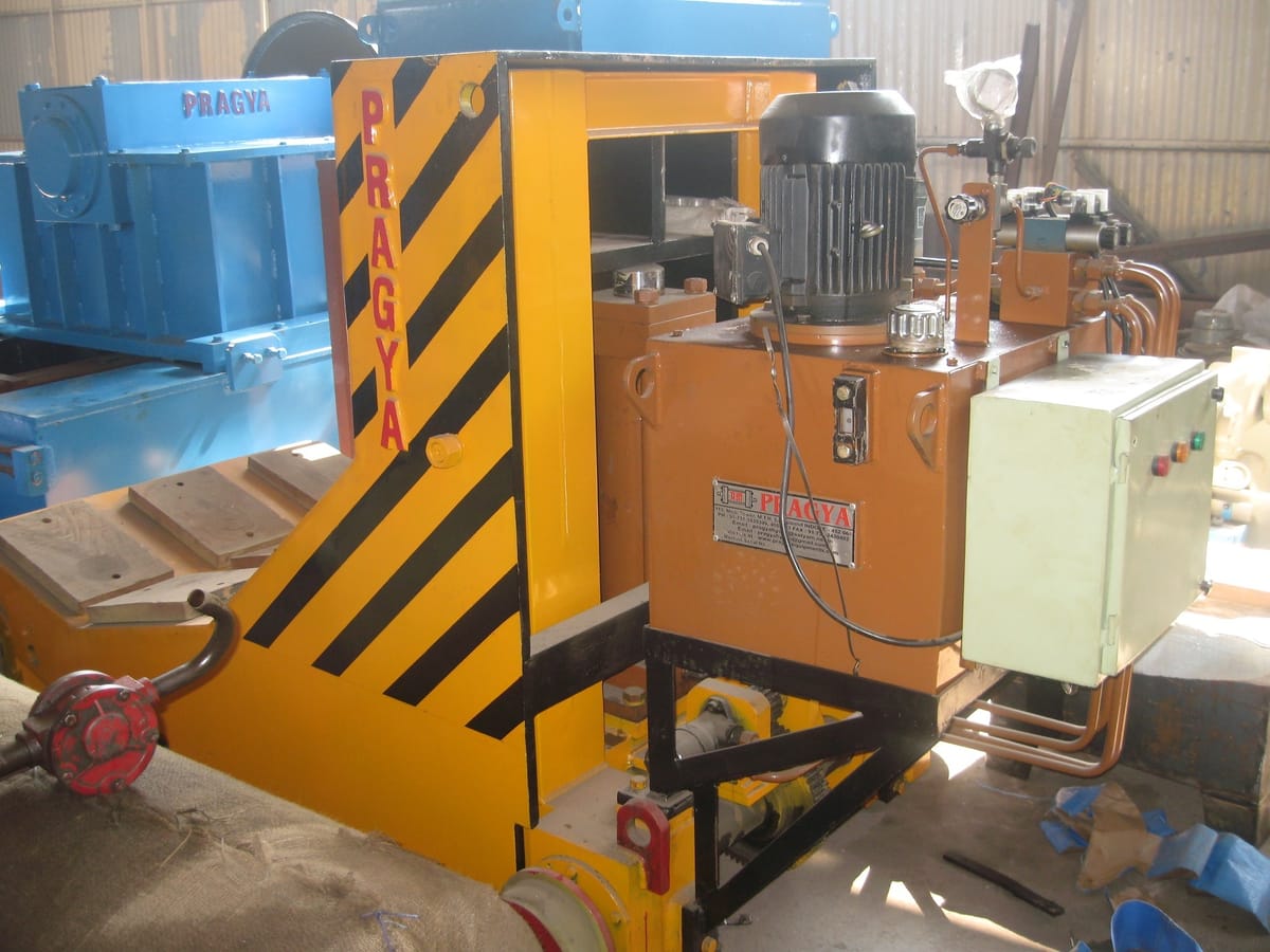 L-type floor transfer trolley moving a coil between processing stations
